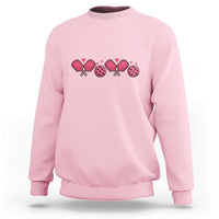 Light pink Valentine’s Day pickleball sweatshirt with pink heart paddle graphic