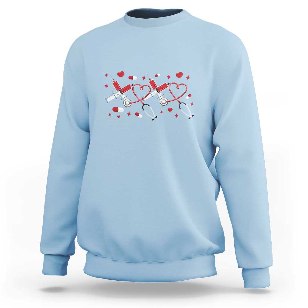 Light blue crewneck sweatshirt with red heart stethoscope graphic on the front