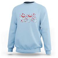 Light blue crewneck sweatshirt with red heart stethoscope graphic on the front