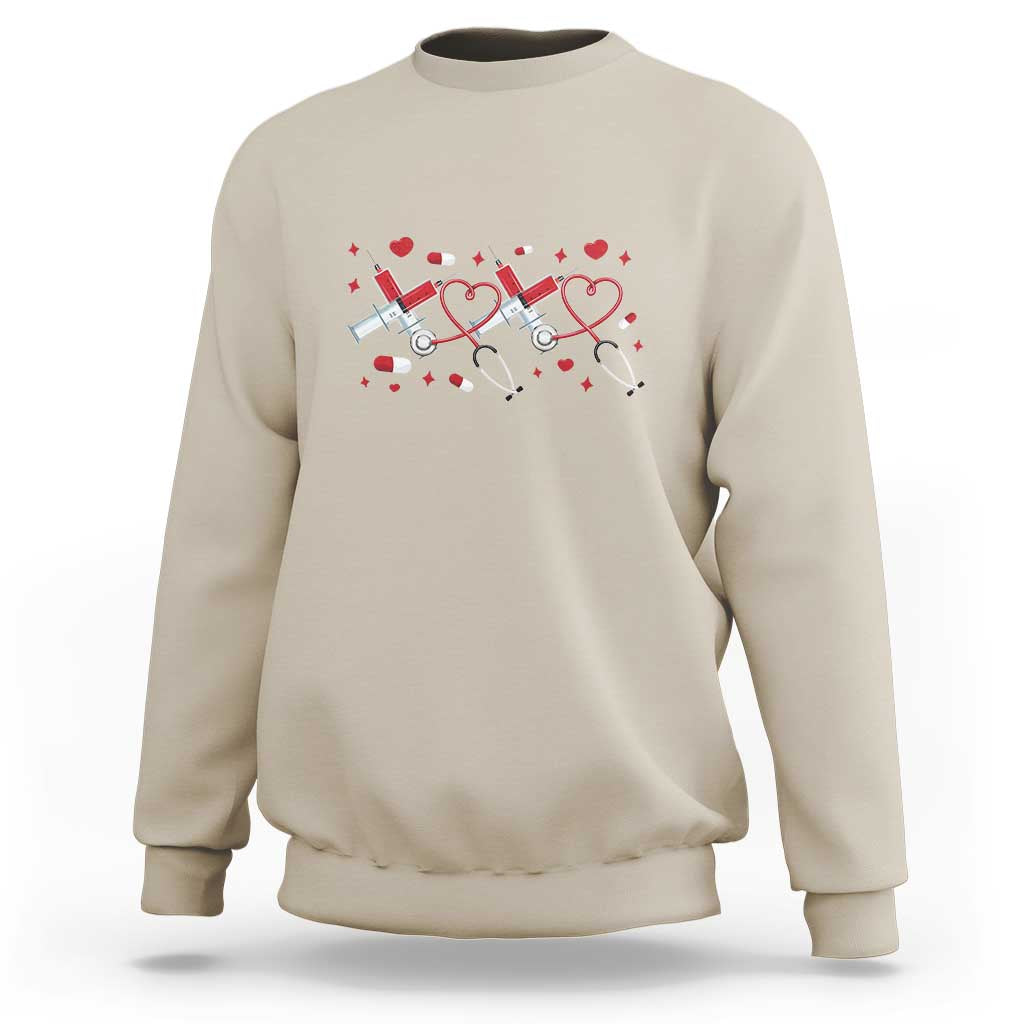 Sand beige crewneck sweatshirt with red heart stethoscope graphic on the front