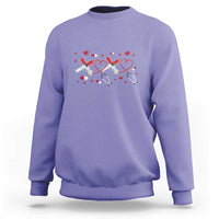 Purple crewneck sweatshirt with red heart stethoscope graphic on the front