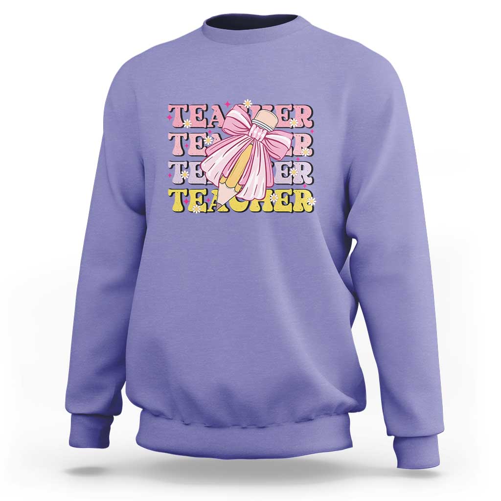 Violet crewneck sweatshirt with teacher-themed graphic and pencil bow on chest