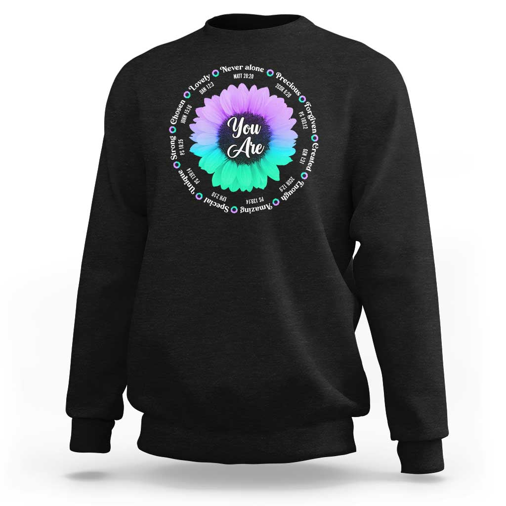 Black crewneck sweatshirt with circular “You Are Never Alone” floral graphic