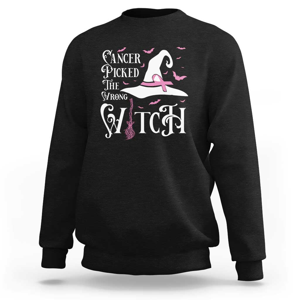 Black crewneck sweatshirt with pink ribbon witch, bat and broom graphic on chest