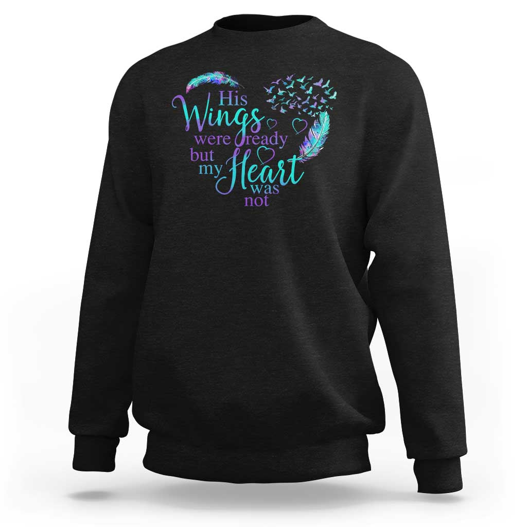 Black crewneck sweatshirt with rainbow wings and heart graphic on the front.