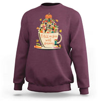 Maroon teacher sweatshirt with pumpkin reading and books graphic, crew neck