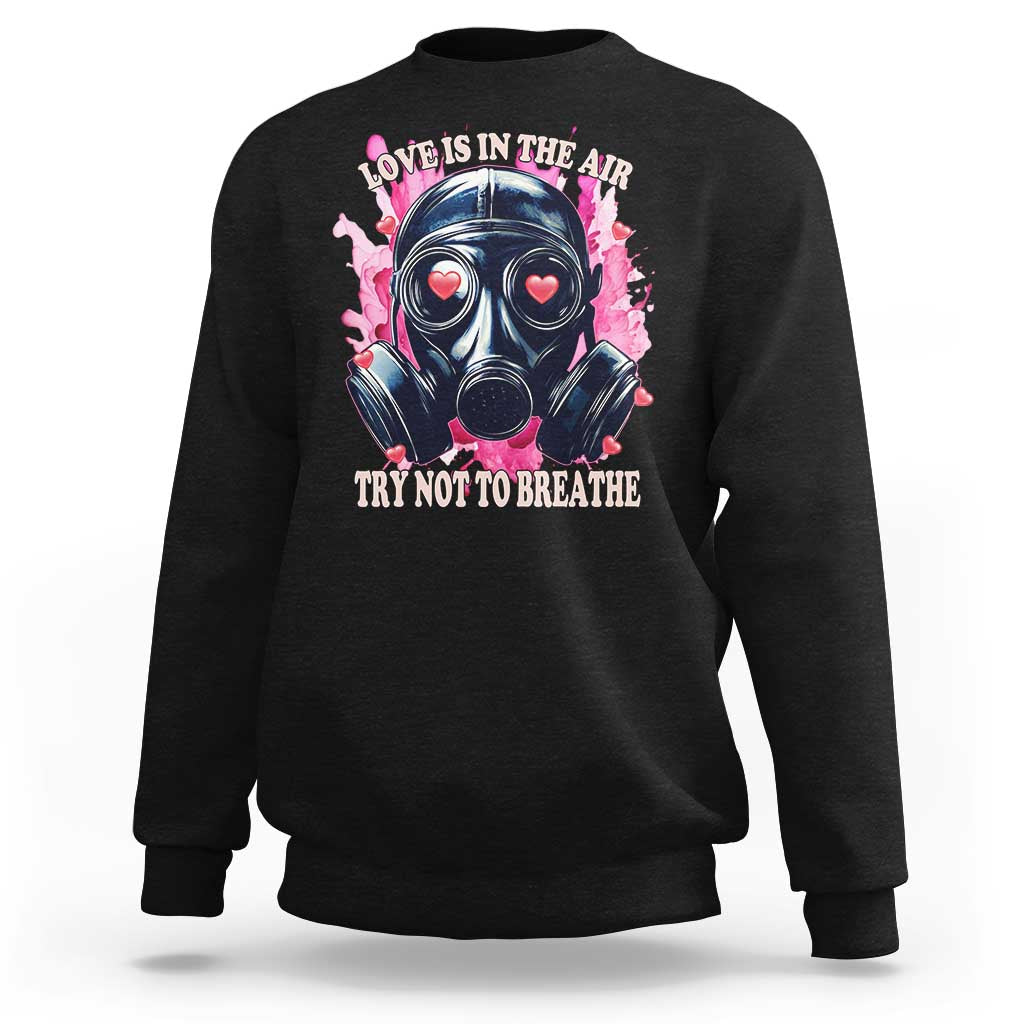 Black sweatshirt with front graphic of gas mask and “Love Is In The Air” text