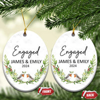 Pair of personalized engaged oval Christmas ornaments with “Engaged,” James & Emily, 2024, front and back.