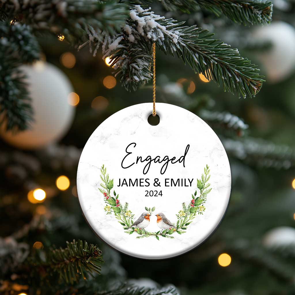 Personalized engaged circle Christmas ornament hanging on a tree: “Engaged,” James & Emily, 2024.