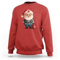 Red crewneck sweatshirt featuring Santa doctor graphic with teal outfit and red cross badge