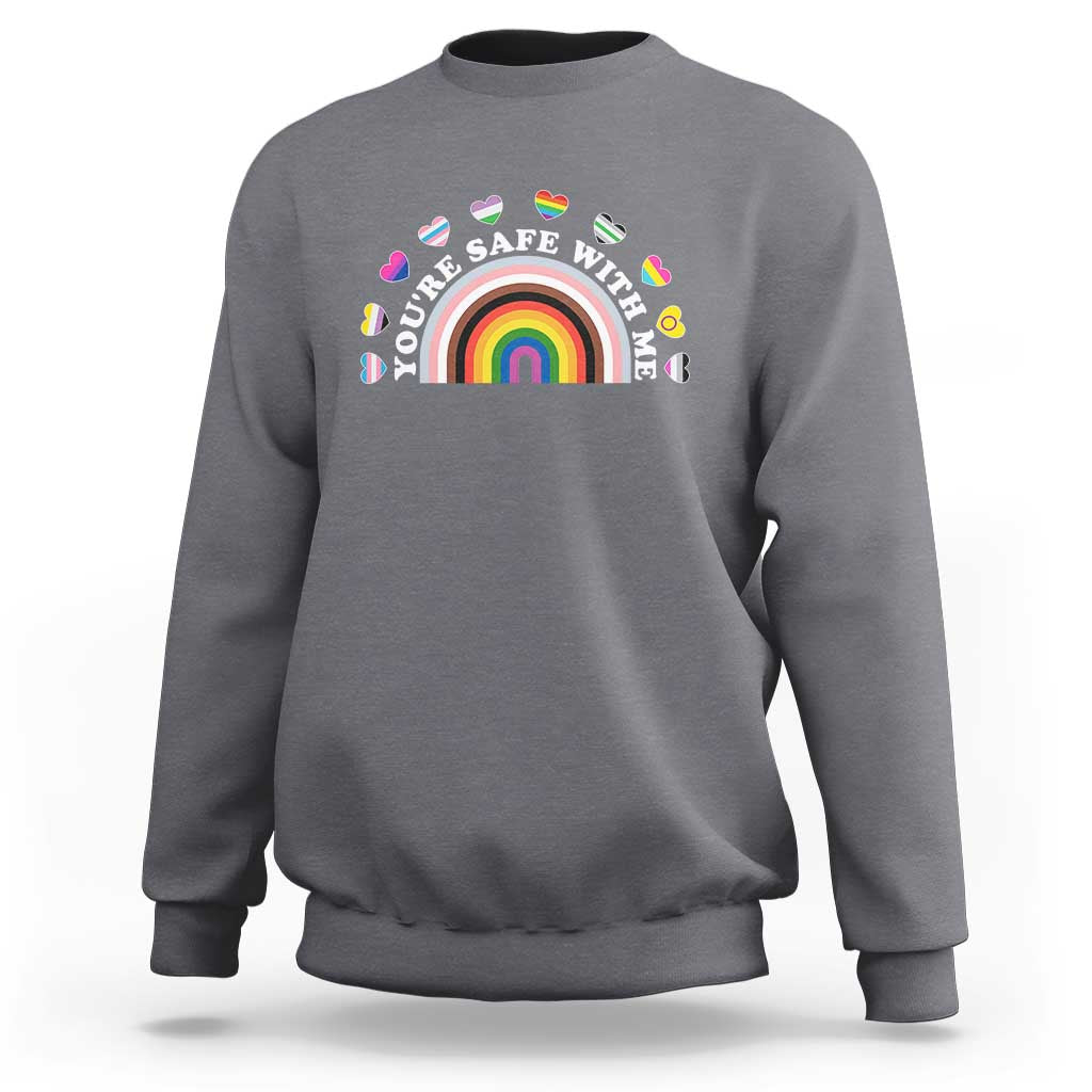 Charcoal gray sweatshirt with rainbow heart pride graphic on the chest