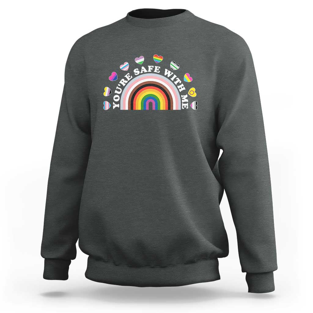 Dark heather gray sweatshirt with rainbow heart pride graphic on the chest