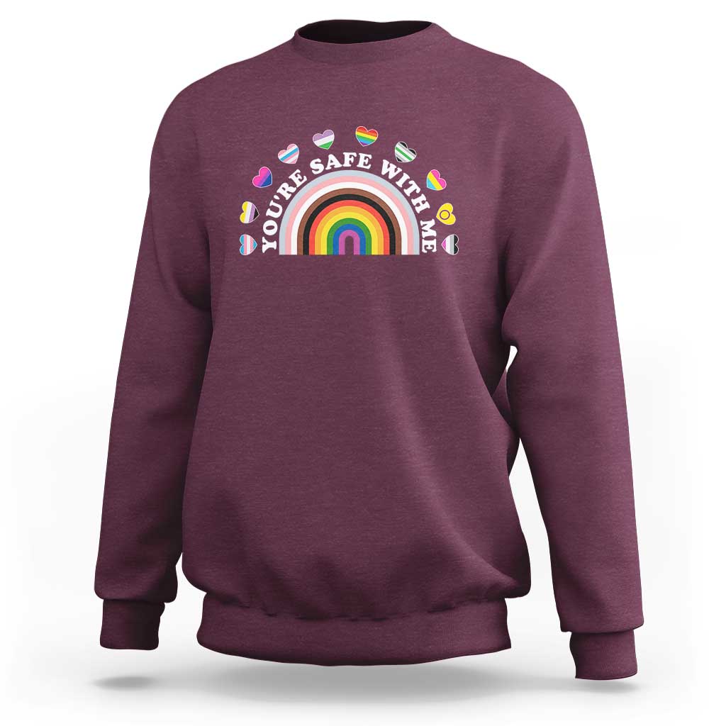 Maroon sweatshirt with rainbow heart pride graphic on the chest