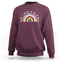 Maroon sweatshirt with rainbow heart pride graphic on the chest