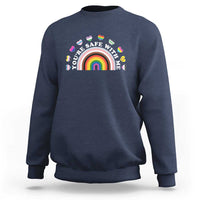 Navy sweatshirt with rainbow heart pride graphic on the chest
