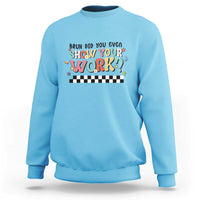 Light blue sweatshirt with colorful 'Show Your Work' text and checkered banner