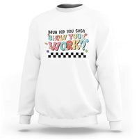 White sweatshirt with colorful 'Show Your Work' text and checkered banner