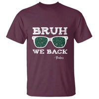 Maroon graphic t-shirt with green glasses print reading 'BRUH' and 'WE BACK'