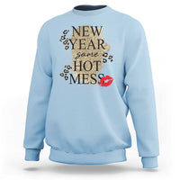 Light blue sweatshirt with “NEW YEAR same HOT MESS” graphic and red lips on front