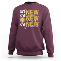 Maroon sweatshirt with front graphic text and gold glitter globe