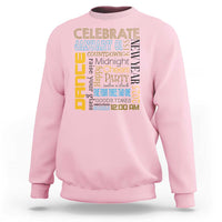 Light pink crewneck sweatshirt with colorful New Year party text graphic on the front