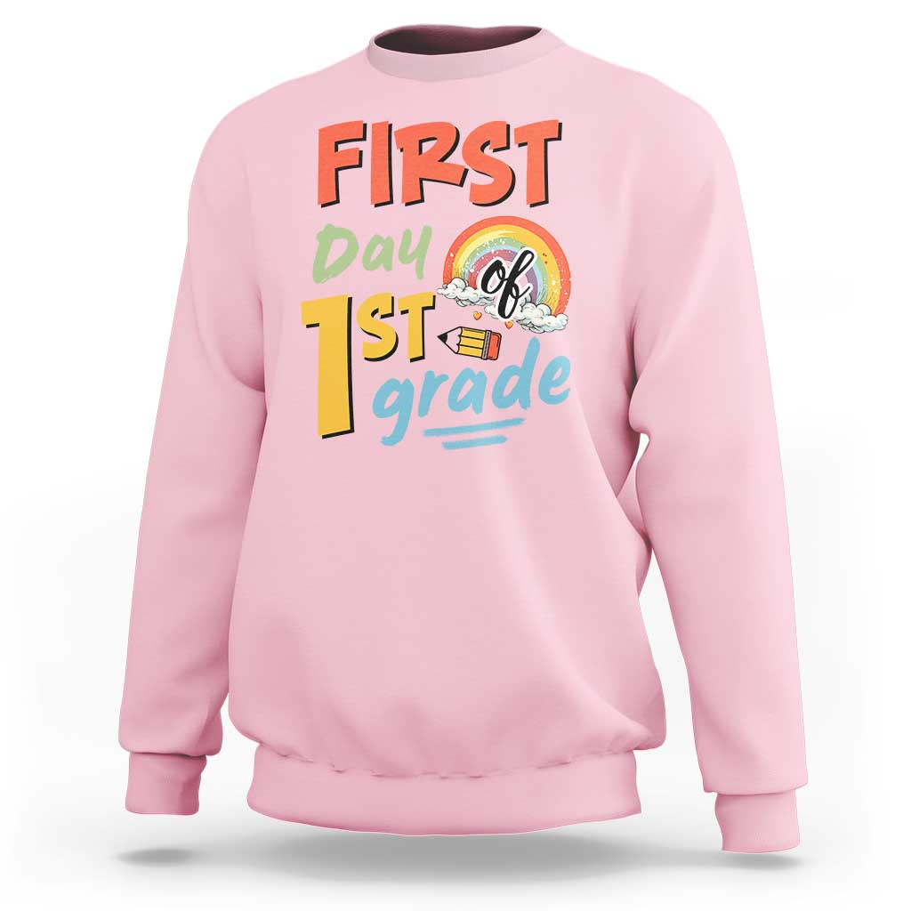 Light pink kids sweatshirt with “First day 1st grade” front graphic and rainbow design