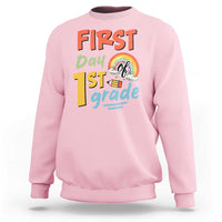 Light pink kids sweatshirt with “First day 1st grade” front graphic and rainbow design