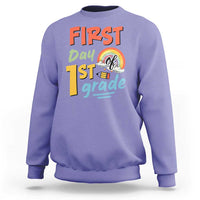 Purple kids sweatshirt with “First day 1st grade” front graphic and rainbow design