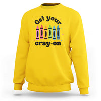 Yellow sweatshirt with front “Get Your Cray-on” text and colorful crayon graphic