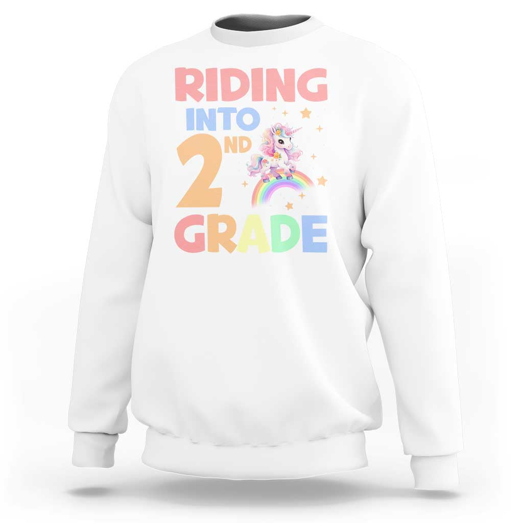 White unicorn sweatshirt with 'Riding into 2nd Grade' rainbow graphic