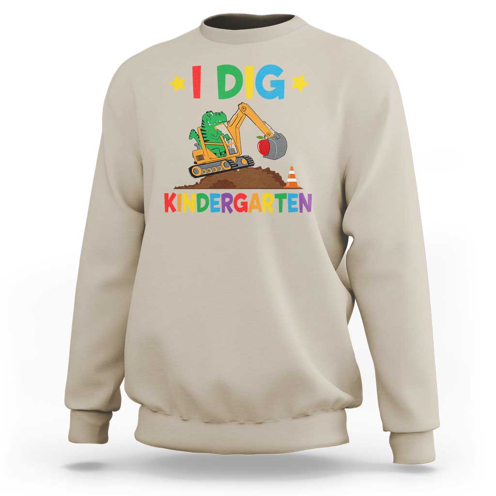 Kids white sweatshirt with “I DIG” dinosaur construction graphic and “KINDERGARTEN” text