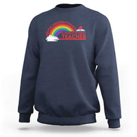 Navy crewneck sweatshirt with “Never Underestimate” rainbow teacher graphic on chest