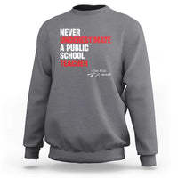 Gray crewneck sweatshirt with centered "Never Underestimate" teacher graphic