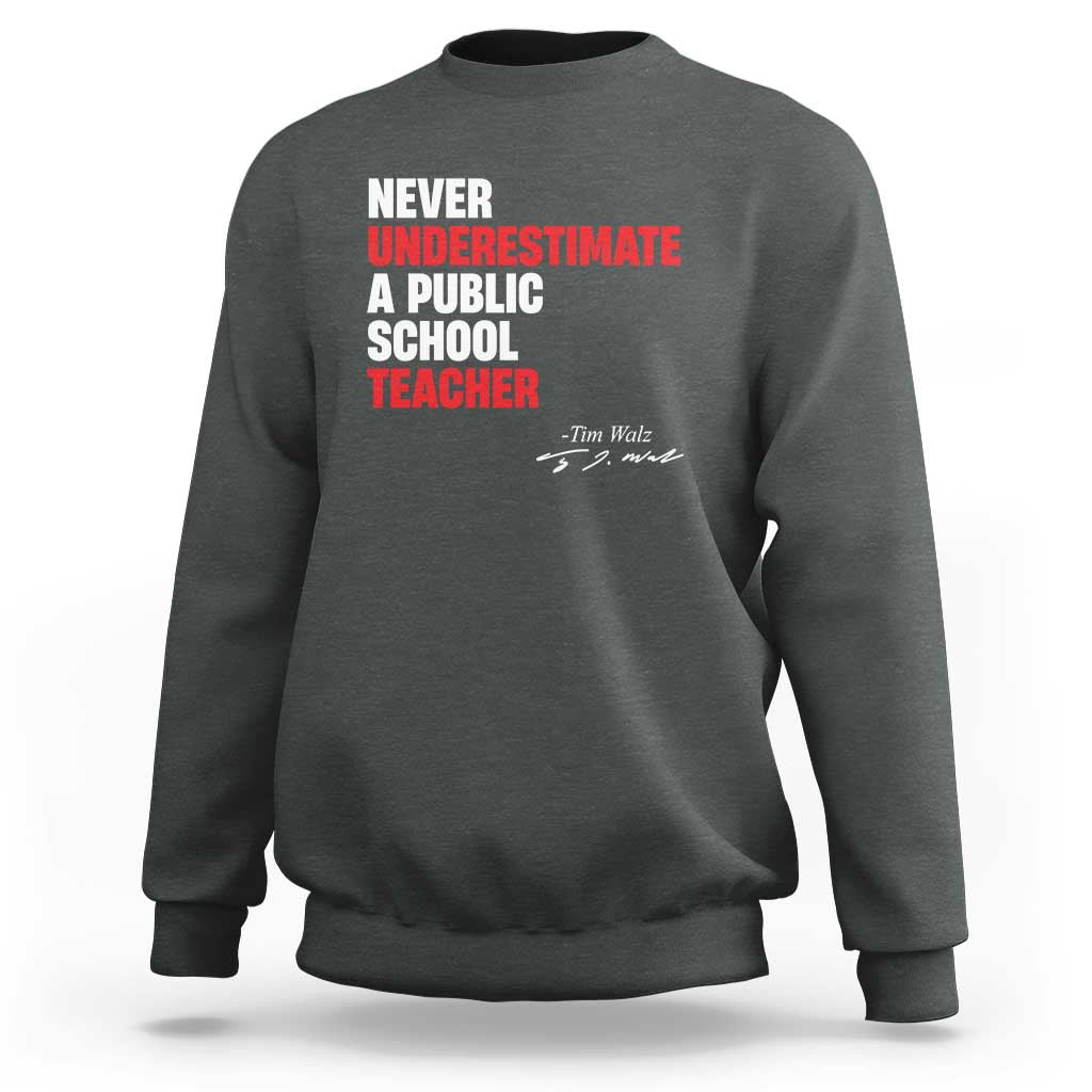 Charcoal crewneck sweatshirt with centered "Never Underestimate" teacher graphic