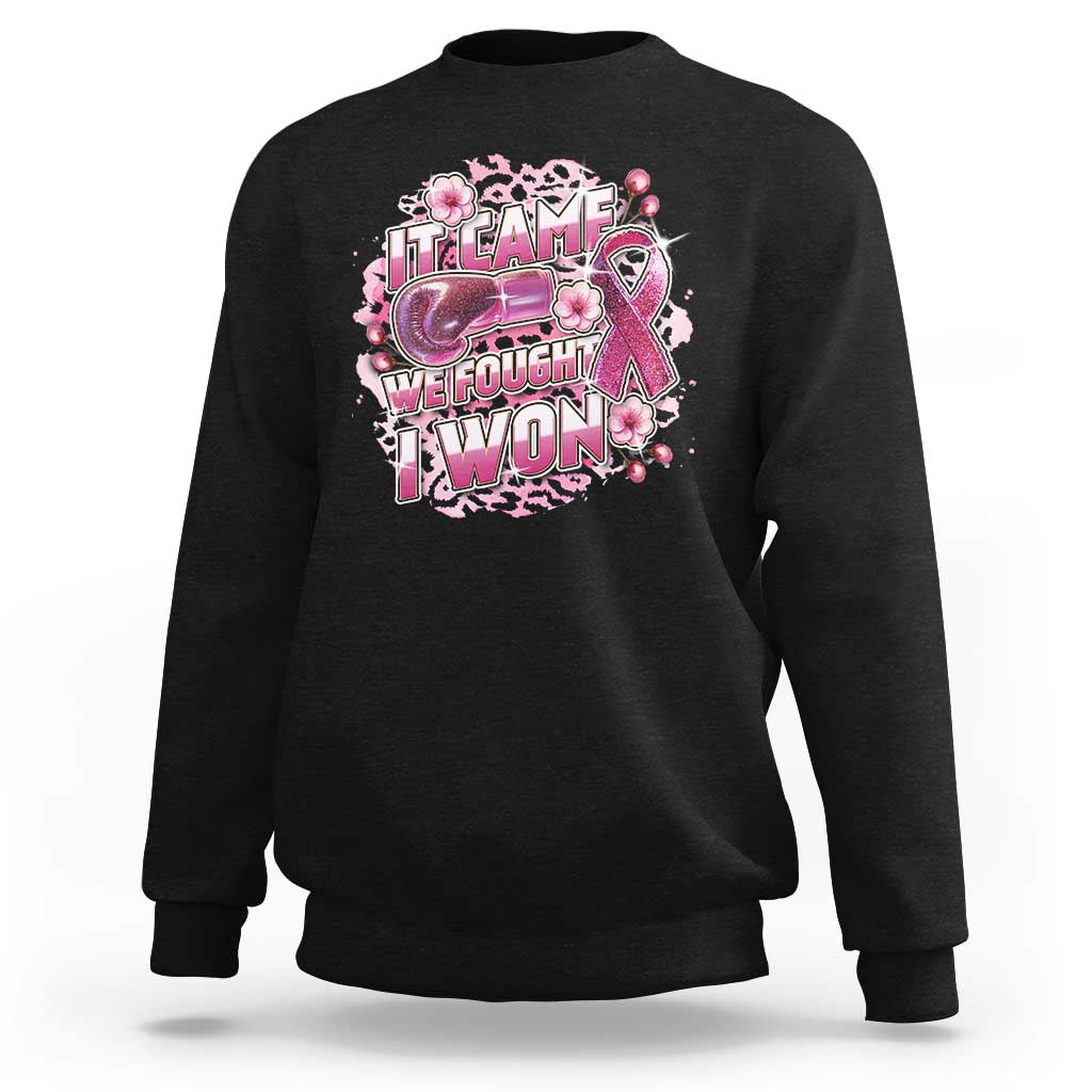Black sweatshirt with pink ribbon leopard boxing glove graphic and 'WE FOUGHT I WON' text