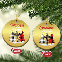 Two gold round Christmas ornaments on a tree, “Christmas begins with Christ” plaid cross graphic