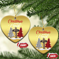 Two gold heart-shaped Christmas ornaments with “Christmas begins with Christ” plaid cross graphic