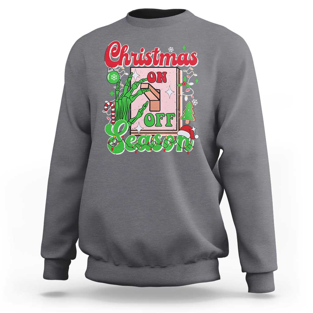 Light gray crewneck sweatshirt with colorful “Christmas on Off Season” skeleton hand graphic