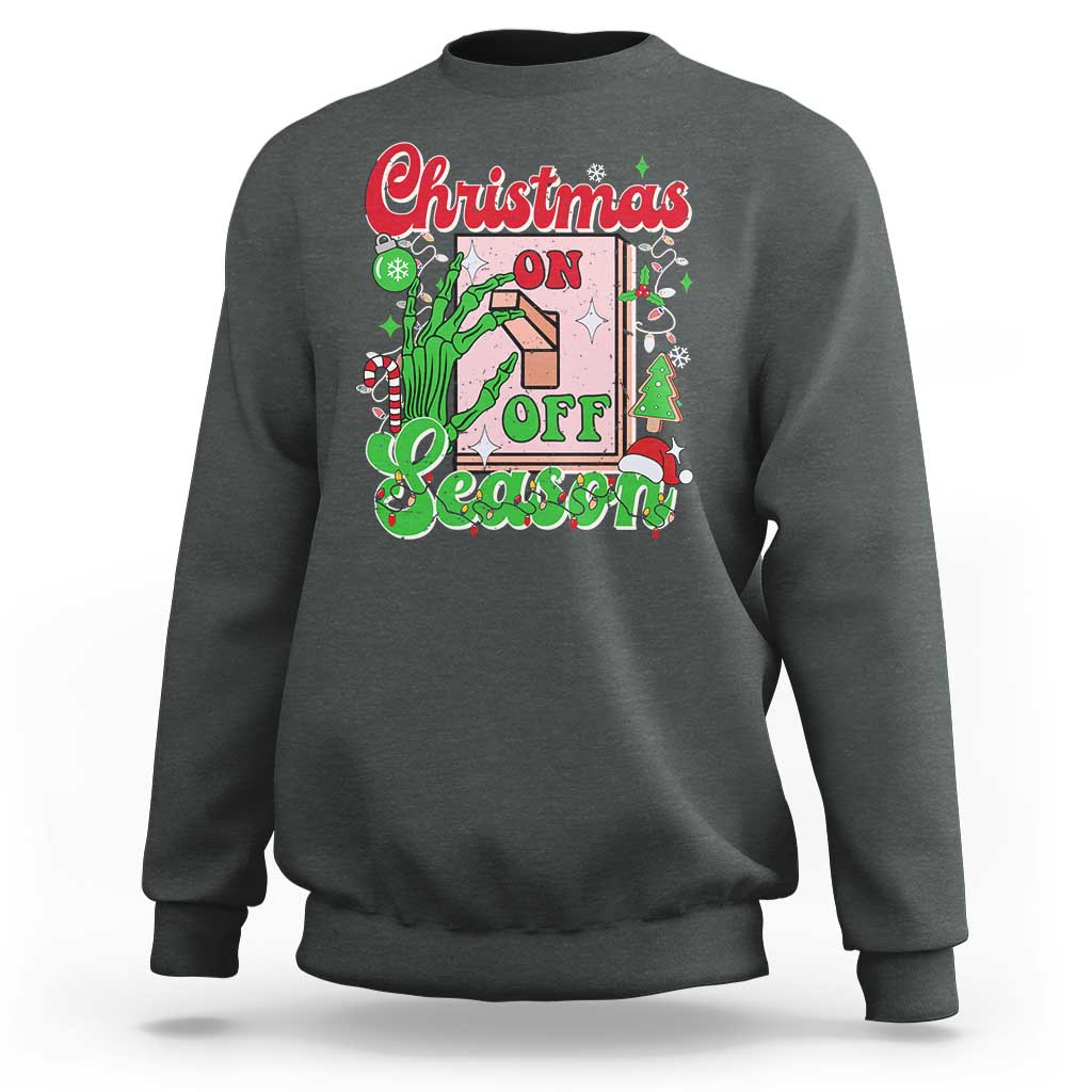 Charcoal crewneck sweatshirt with colorful “Christmas on Off Season” skeleton hand graphic