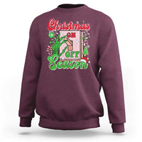 Maroon crewneck sweatshirt with colorful “Christmas on Off Season” skeleton hand graphic