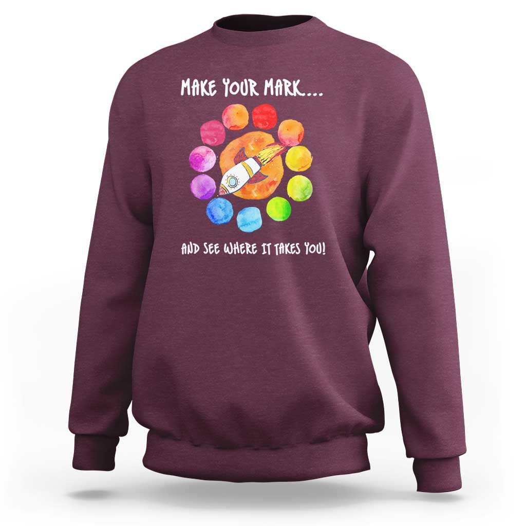 Maroon crewneck sweatshirt with colorful dot rocket graphic on the back