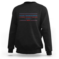 Black crewneck sweatshirt with Never Underestimate teacher graphic on chest