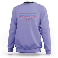 Violet crewneck sweatshirt with Never Underestimate teacher graphic on chest