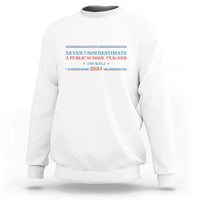 White crewneck sweatshirt with Never Underestimate teacher graphic on chest