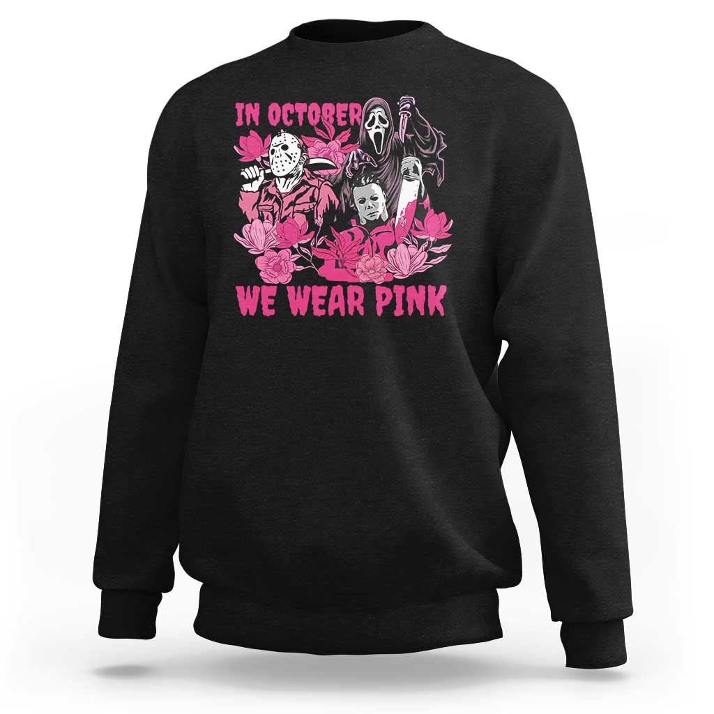 Black crewneck sweatshirt with pink "In October We Wear Pink" graphic on chest