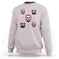 Ice gray sweatshirt with pink bow graphic and skull faces on the front