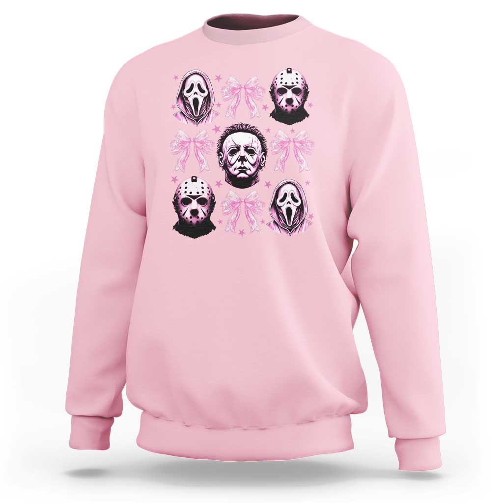 Light pink sweatshirt with pink bow graphic and skull faces on the front