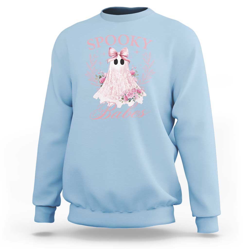 Light blue Halloween sweatshirt with pink ghost graphic, bow, and floral accents on front.