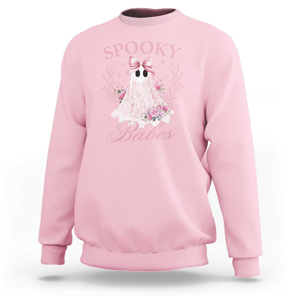 Light pink Halloween sweatshirt with pink ghost graphic, bow, and floral accents on front.