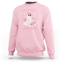 Light pink Halloween sweatshirt with pink ghost graphic, bow, and floral accents on front.